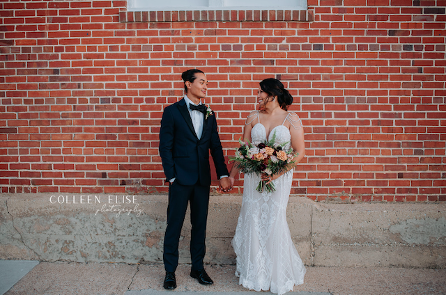 Bride and groom posing outside The Chair Factory wedding venue