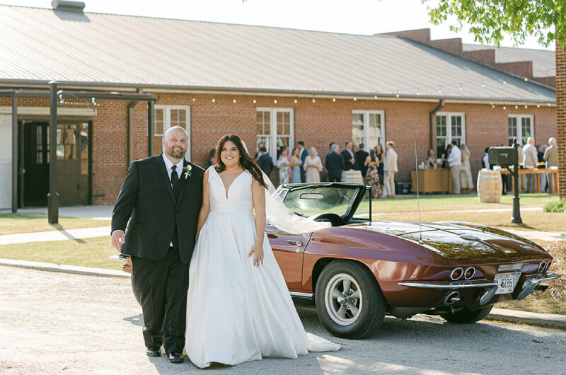 Bride and groom in front of classic car after industrial wedding in North Georgia