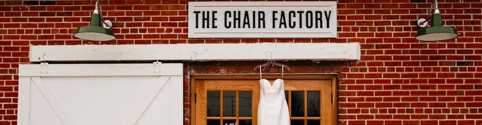 Wedding dress hanging on the exterior of The Chair Factory venue in North Georgia