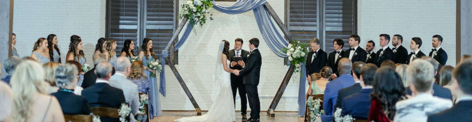 Wedding ceremony inside The Chair Factory industrial wedding venue