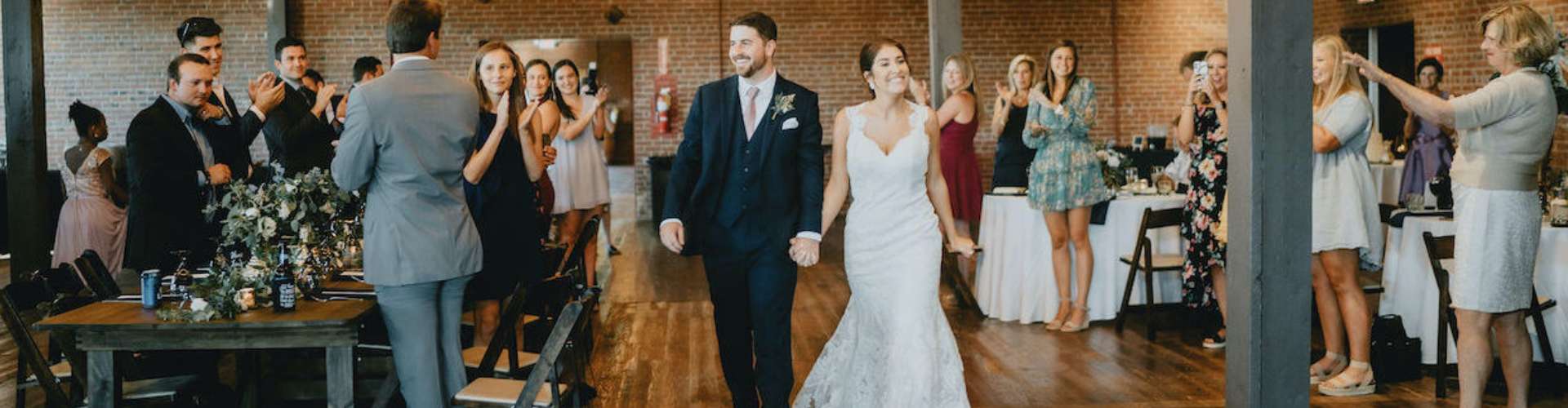 Bride and groom entering reception space in Gainesville wedding venue